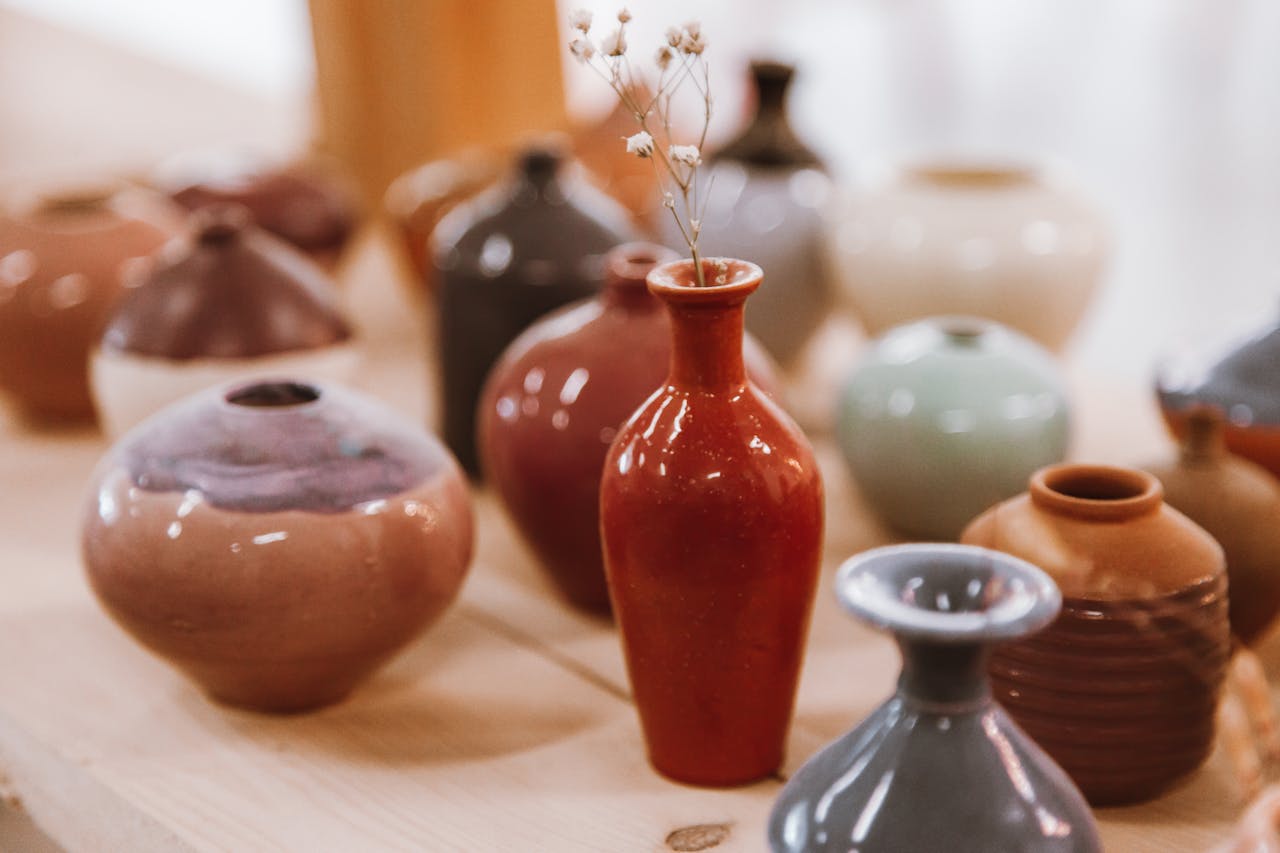 about-01 A beautiful display of assorted ceramic vases with varying colors and textures.
